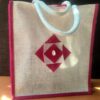 Medium white jute bag with pink motif